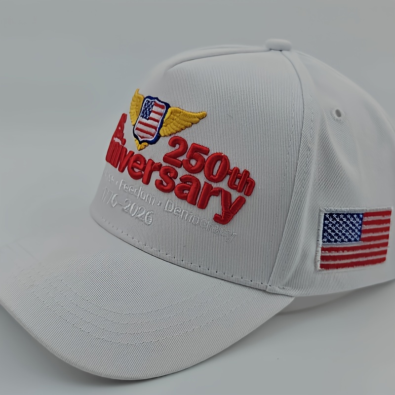A White Baseball Cap with Exquisite Embroidery Patterns And Text On The Front, Red U.S. Anniversary Lettering, Yellow Wing Decorations On Both Sides Of The Logo, Red 250th Lettering On The Right, And Small White Lettering 1776-2026 Holiday Gift Below