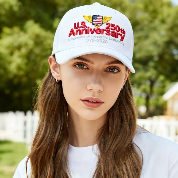 A White Baseball Cap with Exquisite Embroidery Patterns And Text On The Front, Red U.S. Anniversary Lettering, Yellow Wing Decorations On Both Sides Of The Logo, Red 250th Lettering On The Right, And Small White Lettering 1776-2026 Holiday Gift Below